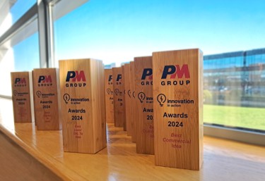 A number of wooden block awards sitting on a windowsill