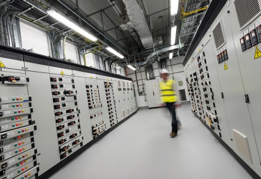 Employee walking through data centre
