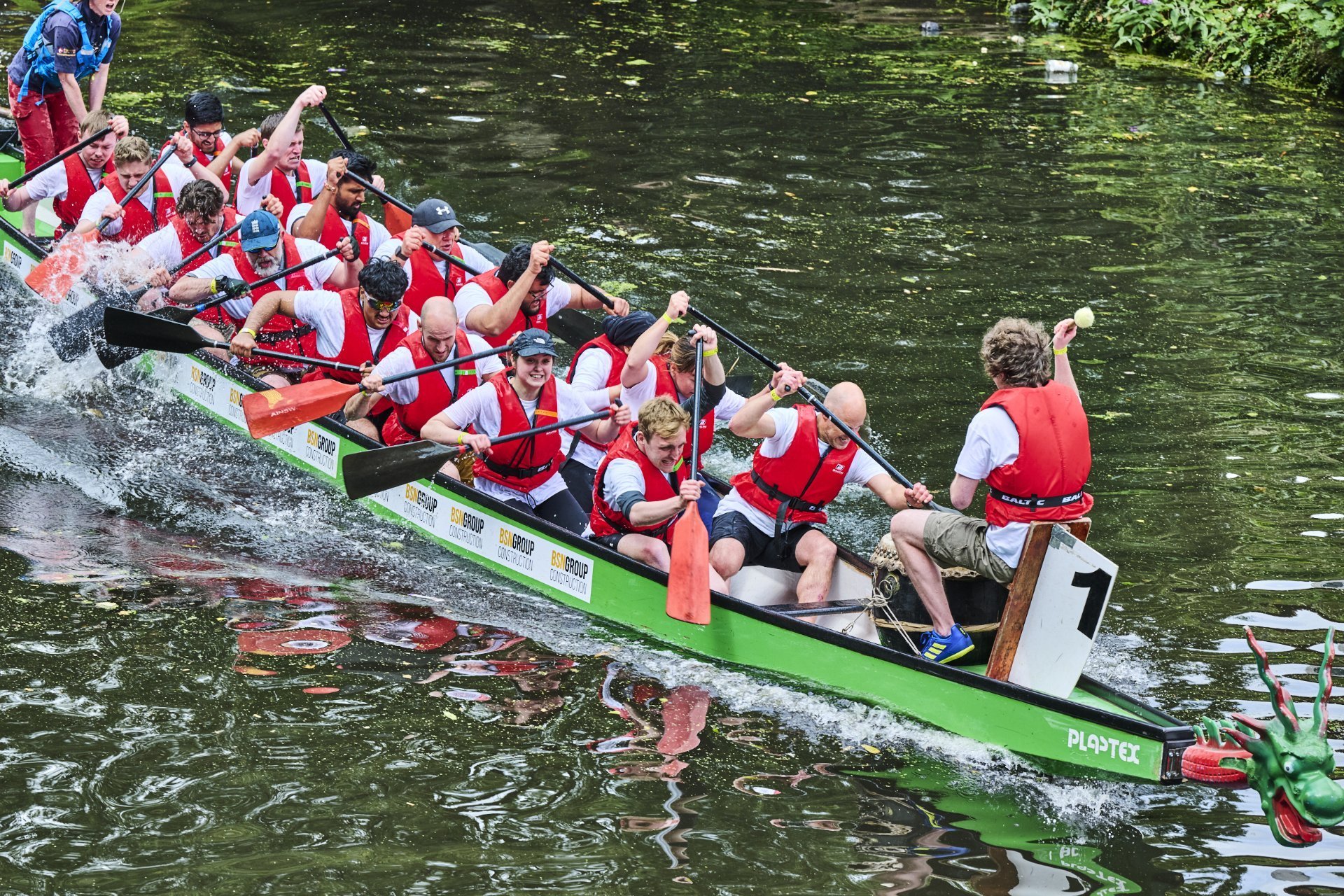 PM Group UK team rowing in a body of water