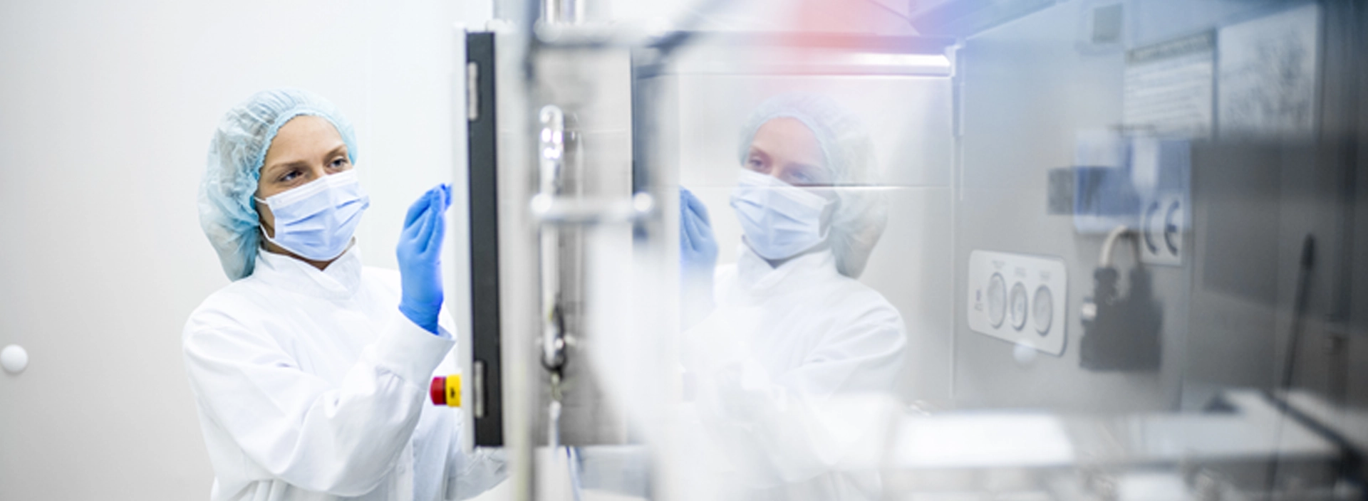 woman in a cleanroom wearing protective gear